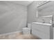 Modern half-bath with clean lines, a white vanity, and a sleek mirror at 1519 N Westmoreland Dr, Orlando, FL 32804
