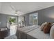 A stylish bedroom with wood floors, a ceiling fan, and sliding glass doors leading to a deck at 1519 N Westmoreland Dr, Orlando, FL 32804