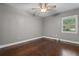 Bright bedroom with dark hardwood floors, ceiling fan, and natural light from the window at 1519 N Westmoreland Dr, Orlando, FL 32804