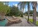 A spacious outdoor deck with wooden lounge chairs, overlooking the neighborhood and mature landscaping at 1519 N Westmoreland Dr, Orlando, FL 32804