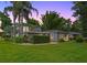 Charming two-story home showcasing mature trees, a well-manicured lawn, and lovely landscaping at 1519 N Westmoreland Dr, Orlando, FL 32804