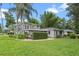 Charming home boasts lush landscaping, and well-manicured lawn at 1519 N Westmoreland Dr, Orlando, FL 32804