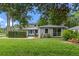 Charming two-story home with manicured lawn, neatly trimmed hedges, and a vibrant turquoise front door at 1519 N Westmoreland Dr, Orlando, FL 32804
