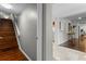 Hallway with wood stairs, light gray walls, and views into the kitchen at 1519 N Westmoreland Dr, Orlando, FL 32804