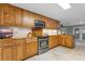 Kitchen featuring stainless steel appliances, wood cabinets, and travertine floors at 1519 N Westmoreland Dr, Orlando, FL 32804