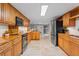 Spacious kitchen with wooden cabinets, stainless steel appliances, and travertine floors at 1519 N Westmoreland Dr, Orlando, FL 32804