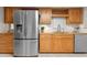 Kitchen featuring wooden cabinets, stainless steel appliances, and travertine floors at 1519 N Westmoreland Dr, Orlando, FL 32804