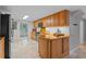 Open kitchen layout with wooden cabinets, stainless appliances, and a breakfast bar at 1519 N Westmoreland Dr, Orlando, FL 32804