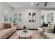 Bright living room with stylish decor, plantation shutters, and view of exterior at 1519 N Westmoreland Dr, Orlando, FL 32804