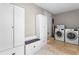 Functional mud room with built-in storage cabinets, bench, and laundry area at 1519 N Westmoreland Dr, Orlando, FL 32804