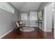 A cozy sitting area with two chairs, wood floors, and a window for natural light at 1519 N Westmoreland Dr, Orlando, FL 32804
