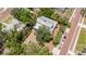 An aerial view of a home surrounded by lush landscaping and a brick street, offering a tranquil and private setting at 16103 Denham Ct, Clermont, FL 34711