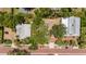 Aerial view of a home with a large lot, several mature trees, brick street, and parking in the front yard at 16103 Denham Ct, Clermont, FL 34711