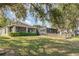 View of backyard with screened in porch and chicken coop at 16103 Denham Ct, Clermont, FL 34711