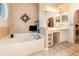 Bright bathroom featuring a soaking tub and vanity with dual sinks at 16103 Denham Ct, Clermont, FL 34711