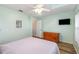 Bright bedroom with wood floors, ceiling fan, and a view to the yard at 16103 Denham Ct, Clermont, FL 34711