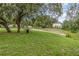 Scenic community park with mature trees, picnic benches, and walking paths, offering a serene outdoor space at 16103 Denham Ct, Clermont, FL 34711