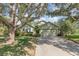 Charming single-story home with a well-manicured lawn and mature trees, offering great curb appeal at 16103 Denham Ct, Clermont, FL 34711