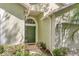 Inviting front door with sidelights and decorative transom window, enhancing the entrance's charm at 16103 Denham Ct, Clermont, FL 34711