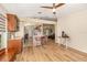 Well-lit kitchen featuring wood floors, granite counters, wood cabinetry, and stainless appliances at 16103 Denham Ct, Clermont, FL 34711