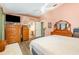 Large main bedroom with ceiling fan, wood floors, and attached bathroom at 16103 Denham Ct, Clermont, FL 34711