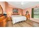 Cozy main bedroom with wood floors, ceiling fan, and painted accent wall at 16103 Denham Ct, Clermont, FL 34711