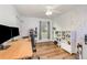 Home office with wood floors, desk, and natural light at 16103 Denham Ct, Clermont, FL 34711