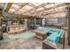 Outdoor kitchen with a gas grill, bar, fire pit, and outdoor seating at 16103 Denham Ct, Clermont, FL 34711