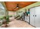 Enclosed patio with overhead ceiling fans, tile flooring, plenty of seating and an outdoor storage cabinet at 16103 Denham Ct, Clermont, FL 34711
