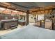 Outdoor patio with a hot tub, outdoor kitchen, bar, seating, and a corrugated roof at 16103 Denham Ct, Clermont, FL 34711