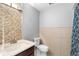 This bathroom has tile detail, and a vanity with marble countertop at 1647 Crestlawn Ave, Orlando, FL 32811