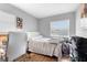 This bedroom features a white bed, desk, and natural light from two windows at 1647 Crestlawn Ave, Orlando, FL 32811