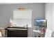 Cozy bedroom featuring a piano, television, and natural light from the window at 1647 Crestlawn Ave, Orlando, FL 32811