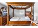 Bedroom featuring a four post wooden canopy bed with decorative detail, and a television at 1647 Crestlawn Ave, Orlando, FL 32811