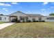 Charming single-story home with a covered parking area and well-maintained landscaping at 1647 Crestlawn Ave, Orlando, FL 32811