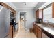 The kitchen boasts stainless steel appliances, granite countertops, and tile flooring at 1647 Crestlawn Ave, Orlando, FL 32811