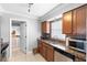 Well-lit kitchen boasts granite countertops, stainless steel appliances, and modern finishes at 1647 Crestlawn Ave, Orlando, FL 32811