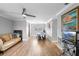 Bright living room featuring hardwood floors, a ceiling fan, and neutral wall colors at 1647 Crestlawn Ave, Orlando, FL 32811