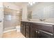 This bathroom features a double vanity, a glass enclosed shower and tile flooring at 178 Windflower Way, Oviedo, FL 32765