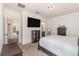 Bedroom with a large television, neutral paint, closet, and carpet flooring at 178 Windflower Way, Oviedo, FL 32765