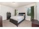 Bedroom featuring neutral paint, carpet flooring, and two windows with green curtains at 178 Windflower Way, Oviedo, FL 32765