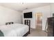 A cozy bedroom boasts a queen-size bed and a modern bathroom ensuite, offering a comfortable retreat at 178 Windflower Way, Oviedo, FL 32765