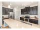 Kitchen featuring a stainless steel refrigerator, countertops, dark cabinets, and tile backsplash at 178 Windflower Way, Oviedo, FL 32765