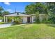 Charming single-story home featuring a quaint front yard and a convenient carport at 1877 Attucks Ave, Orlando, FL 32811