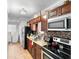 Modern kitchen featuring stainless steel appliances, dark cabinets, and tile backsplash at 1877 Attucks Ave, Orlando, FL 32811