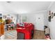 Cozy living room featuring a red couch, neutral colors, and a large window at 1877 Attucks Ave, Orlando, FL 32811