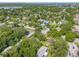 Scenic aerial of tree-lined streets, revealing well-kept houses in a serene, established community at 1901 Loch Berry Rd, Winter Park, FL 32792