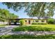 Charming single-story home with a well-manicured lawn and covered carport at 1901 Loch Berry Rd, Winter Park, FL 32792