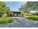 Inviting single-Gathering home featuring a spacious carport and lush green lawn at 1901 Loch Berry Rd, Winter Park, FL 32792