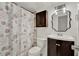This charming bathroom showcases an ornate mirror and themed curtain at 1940 S Conway Rd # 8, Orlando, FL 32812